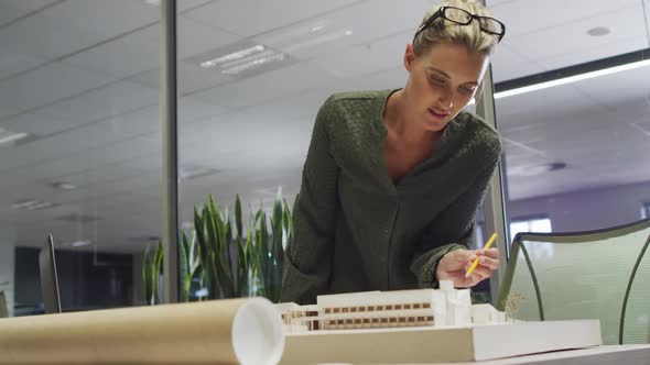 Video of focused caucasian female designer working on project