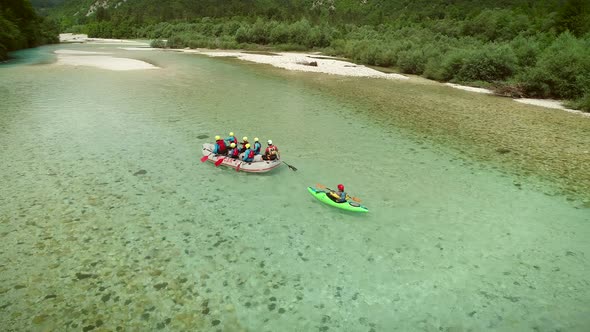 Aerial view of a group of rafters doing rafting and going down the Soca River.