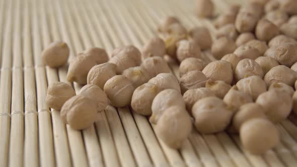 Uncooked dry chickpeas close-up on a bamboo mat