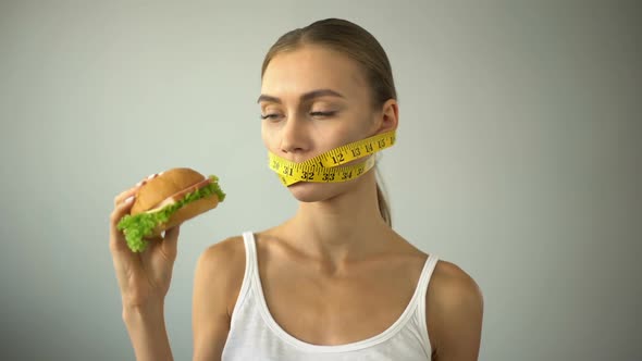 Anorexic Girl Ties Mouth With Tape-Line, Fights With Temptation to Eat Burger