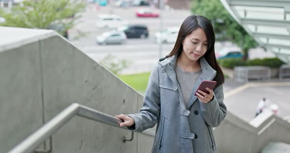 Woman use of mobile phone in city