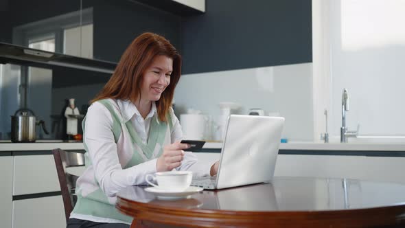 Happy Woman Ordering Online with Credit Card