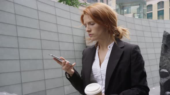 Businesswoman using smart phone and on the move