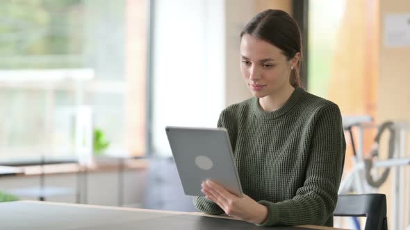 Young Woman Using Tablet for Online Work