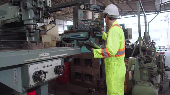 Smart Factory Worker Using Machine in Factory Workshop