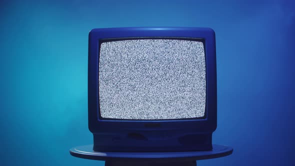 Old Vintage Television on Blue Neon Background Closeup