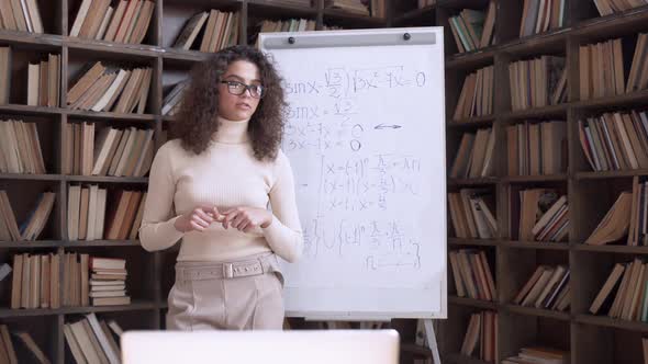 Confident Hispanic Young Woman Math Teacher Giving Remote Online Class Concept