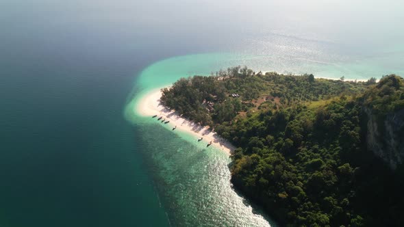 high altitude aerial top down view of Ko Poda Island white sand beaches full of thai longtail boats