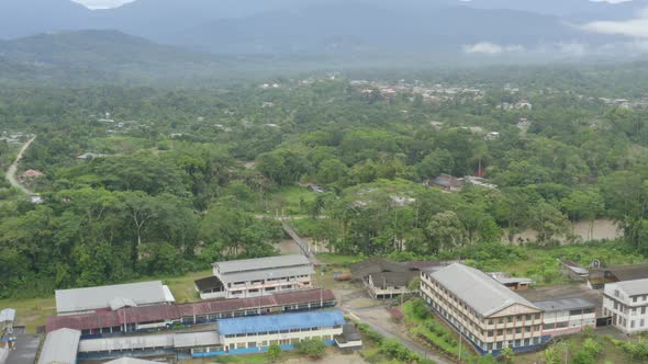 Aerial view circling around a small ranch at the edge of the city