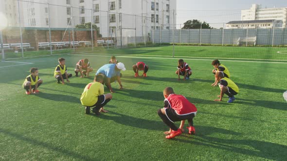 Soccer kids exercising in a sunny day