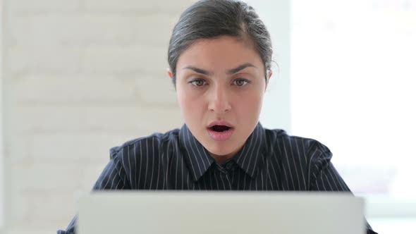 Close Up of Indian Woman with Laptop Reacting to Loss