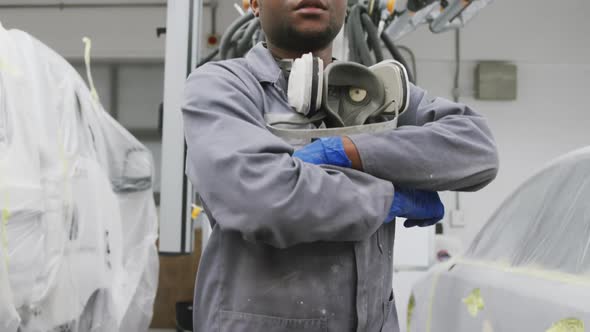 African American male car mechanic crossing his arms and looking at camera