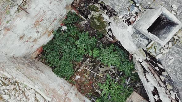 Ruins of abandoned old broken industrial factory or warehouse buildings after disaster