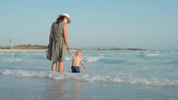 Happy Woman and Kid Staying at Beach