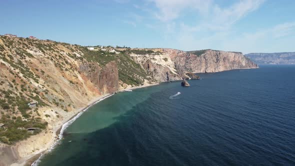 Aerial View From Above on Calm Azure Sea and Volcanic Rocky Shores