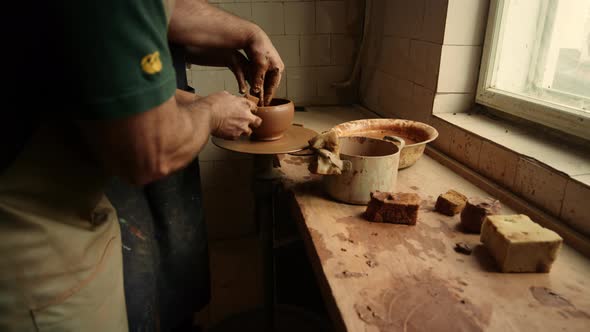 Woman Sculpting Pot in Pottery in Slow Motion