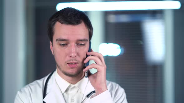 Doctor Speaks On Smartphone In Office