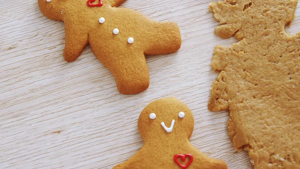 Gingerbread dough with cookie cutter on wooden table 4k