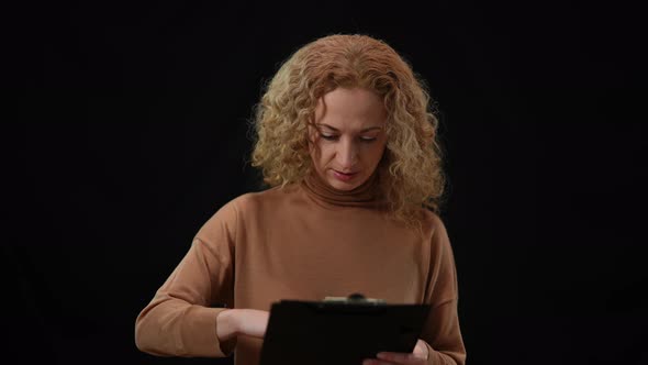 Inspired Motivated Caucasian Woman Gesturing Talking to Audience at Black Background