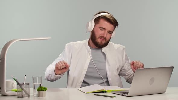 Student Tired of Watching Online Webinar Turns on Music and Relaxes in Big White Headphones