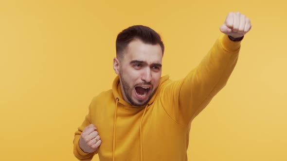 Expressive young man screaming and shouting over vibrant background.