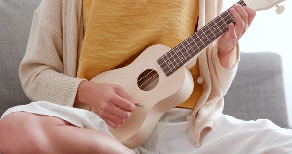 Woman Playing Song with Ukulele