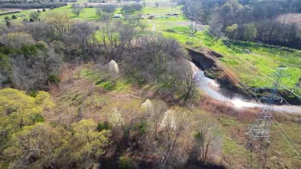 Aerial footage of Post Oak Creek in Sherman Texas. Drone is flying along power lines.