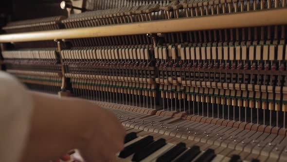 Woman Play on Open Vintage Wooden Piano