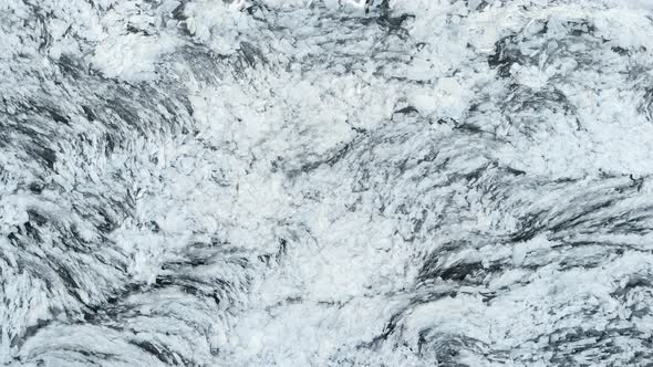 Aerial View of a Frozen River. Fancy Ice Texture, Cold Chained Water. Shards of Ice Stick Out with