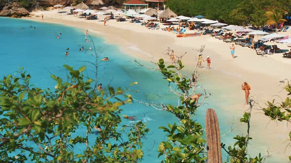 Grote Knip Beach In Curacao - Tourists Enjoying The Bright Blue Sea Water While Others Are Sunbathin