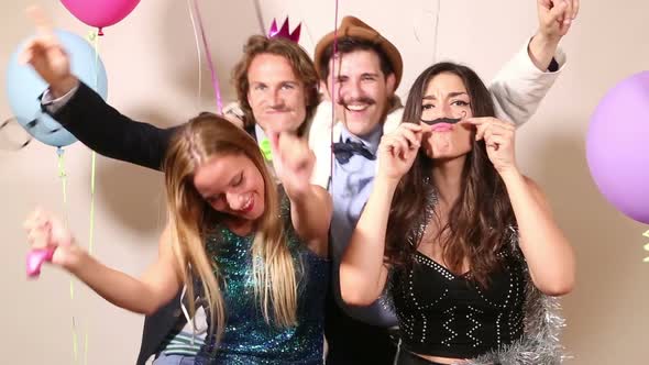 Friends enjoying in party photo booth