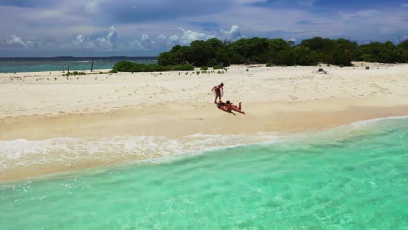 Girls look beautiful on tranquil seashore beach voyage by blue lagoon with white sandy background of