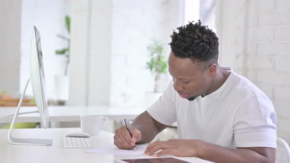 Hardworking Casual African Man Using Desktop in Office 