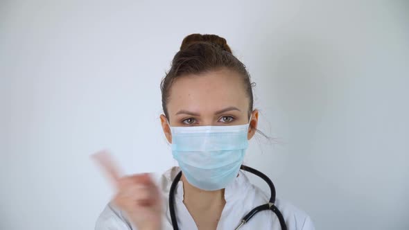 Close Up of Caucasian Doctor with a Stethoscope in Protective Mask, Covid-19 Protection