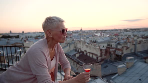 Blonde Woman with Red Wine on Roof