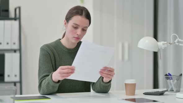 Young Woman Reading Documents 