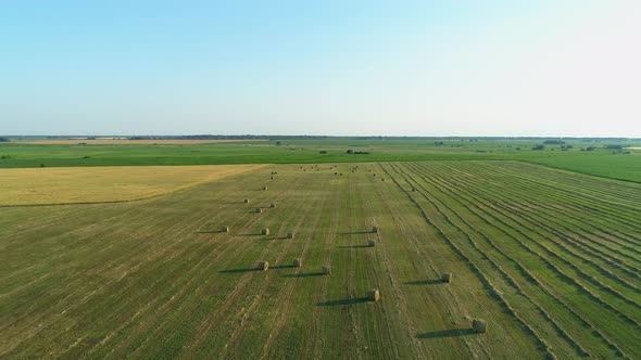 Aerial View Hay Bales at Agricultural Field in Summer at Sunset Haystack