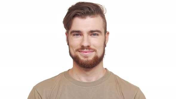 Handsome Caucasian Male with Brown Beard and Khaki Tshirt Smiling on White Background