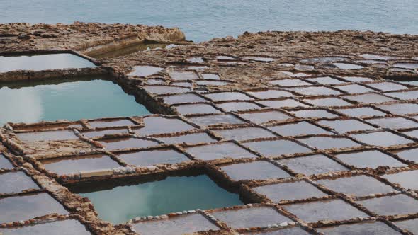 Top view of saltpans in front of the sea