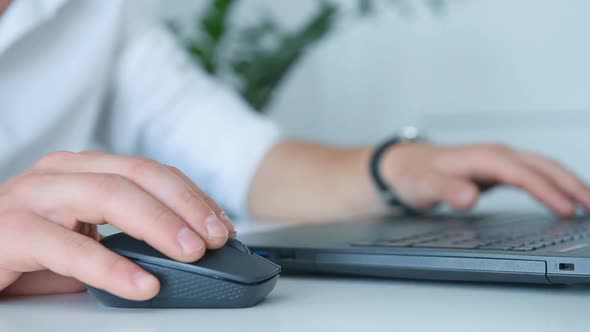 Businessman Sitting In Office And Using Laptop