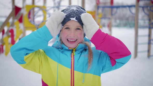 Little Girl Playing Peek-a-boo with the Camera at Winter Park