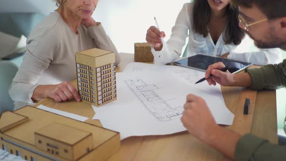 Three architects talking to each other during meeting in an office