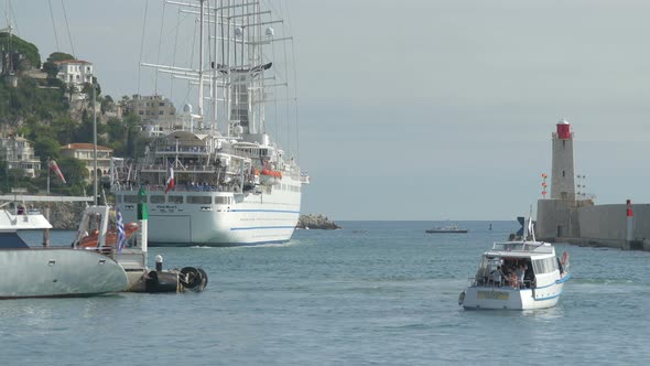 A ship and a boat sailing away from a harbor