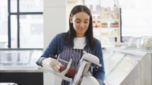 Animation of happy biracial waitress using meat cutting machine