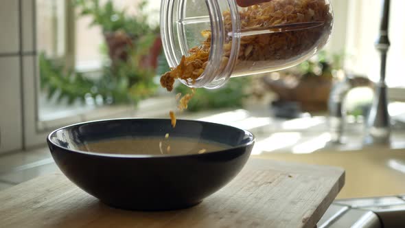 CLOSE UP Pouring a bowl of cereal on kitchen counter