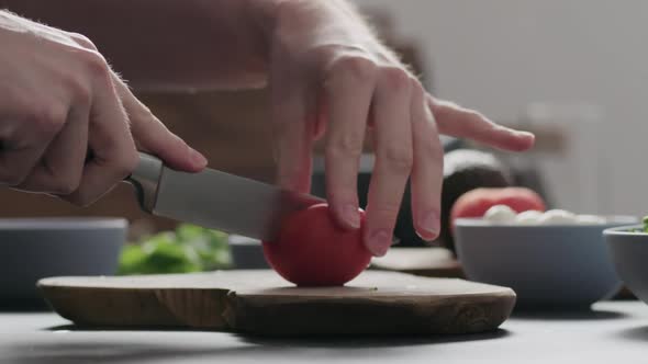 Slow Motion Man Make Salad with Kale Mozzarella Avocado and Cherry Tomatoes Cut Cherry Tomatoes