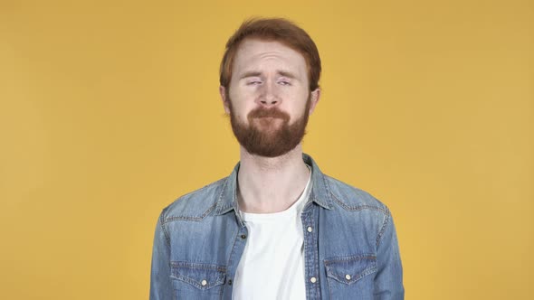 Redhead Man Shaking Head To Reject Yellow Background