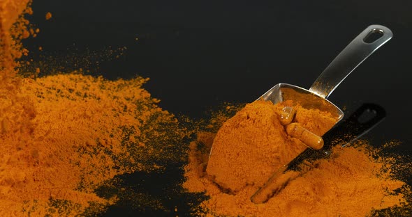 Turmeric, curcuma longa, Powder falling against Black Background, Indian Spice, Slow Motion 4K