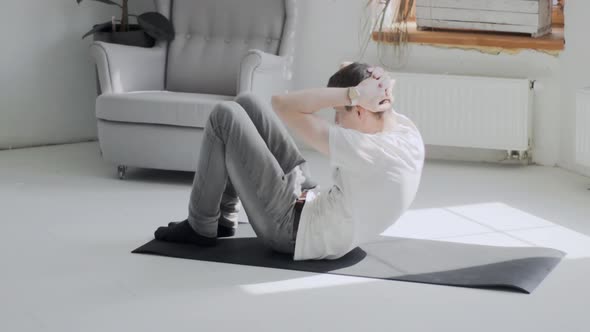 Young Man Rising His Body While Lying on Mat