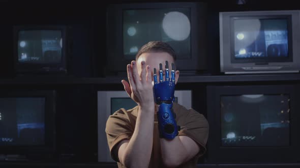 A Disabled Man Blogger Shows Gestures with His Hand and Bionic Prosthesis